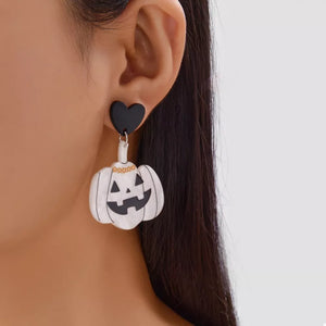ivory earrings featuring drop design and graphic