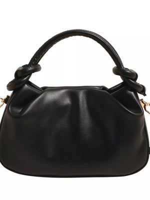 Black ruched crossbody bag with knotted top handle and gold hardware detail