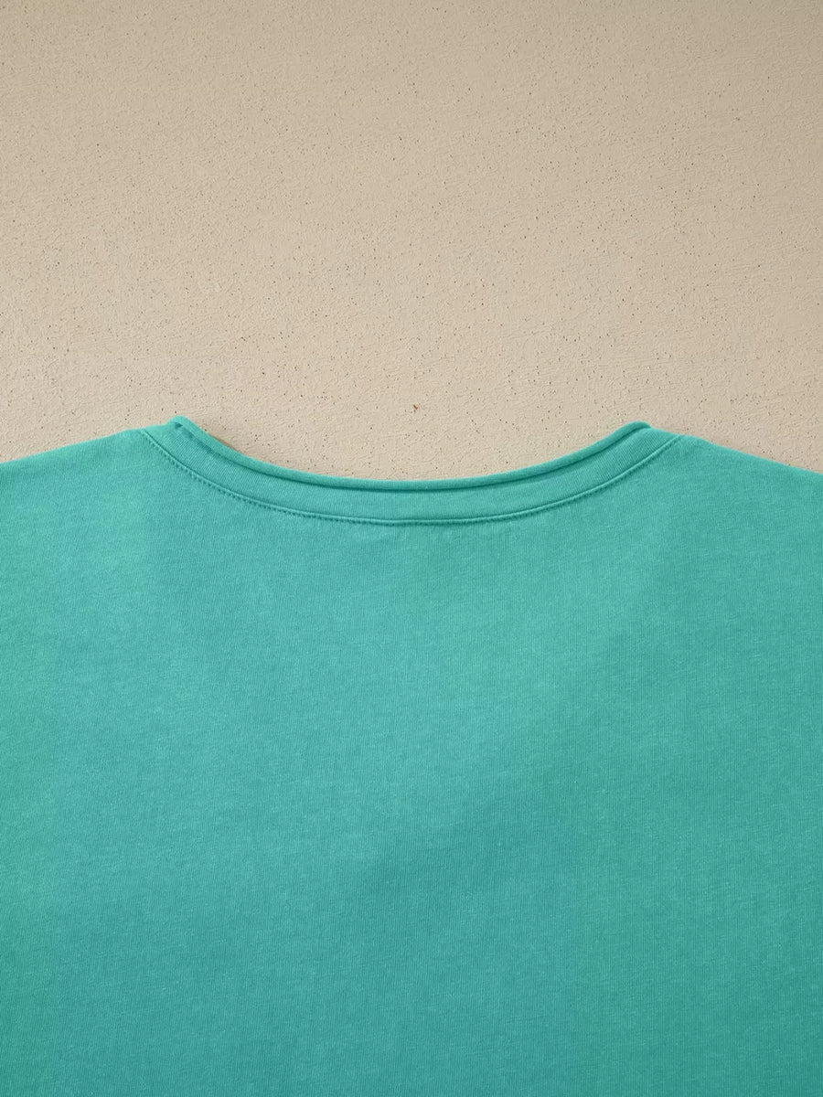 Mineral wash teal cotton maternity t-shirt with crew neck and short sleeves.