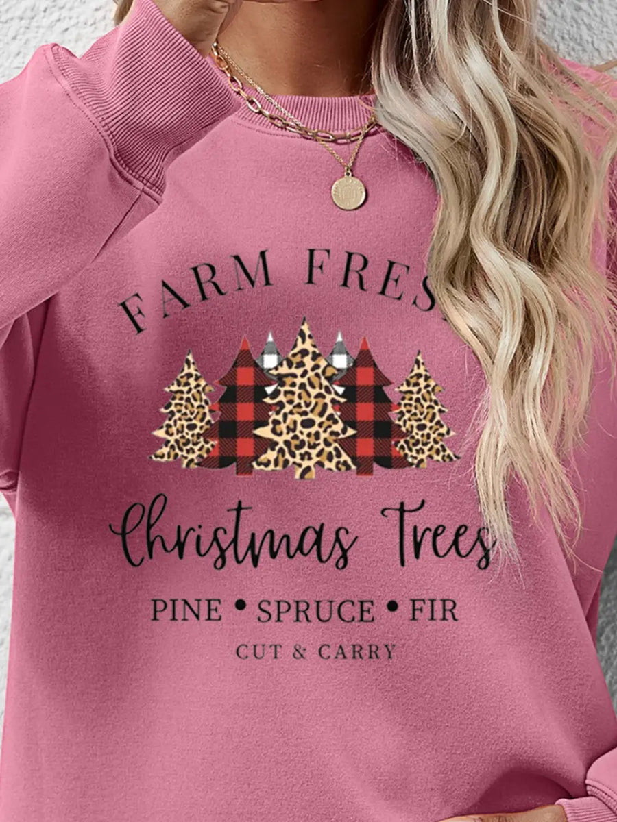 Christmas graphic crewneck sweatshirt in Blush Pink with festive tree print and text.
