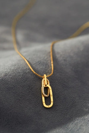 Gold linked pendant necklace with cubic zirconia and engraved letters.