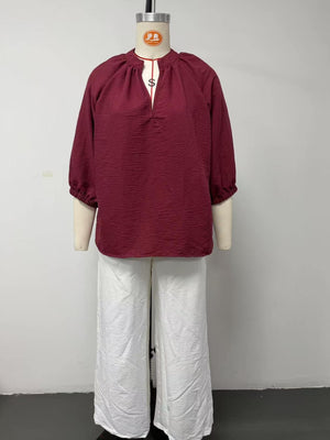 100% polyester Care instructions: Machine wash cold blouse and wide-leg pants set in ivory with relaxed silhouette
