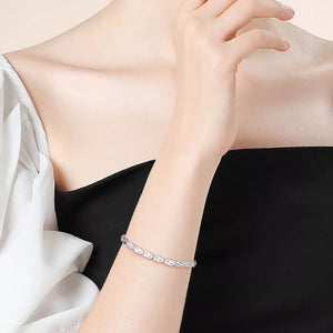Interconnected heart link bracelet in sterling silver with delicate chain detail.