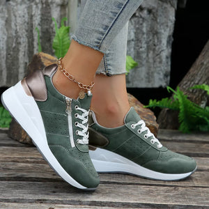 Dark green lace-up wedge sneakers with side zipper and white sole.