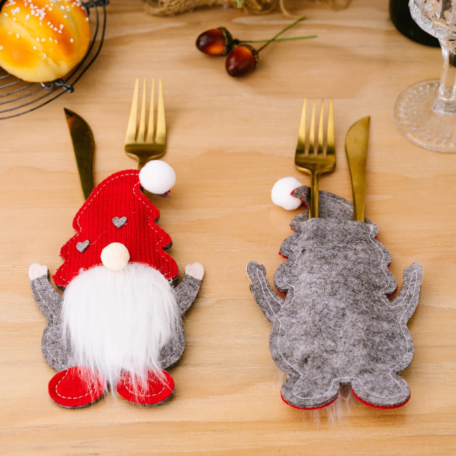 Festive gnome cutlery holders in red and gray, with white beards and pom-pom hats.