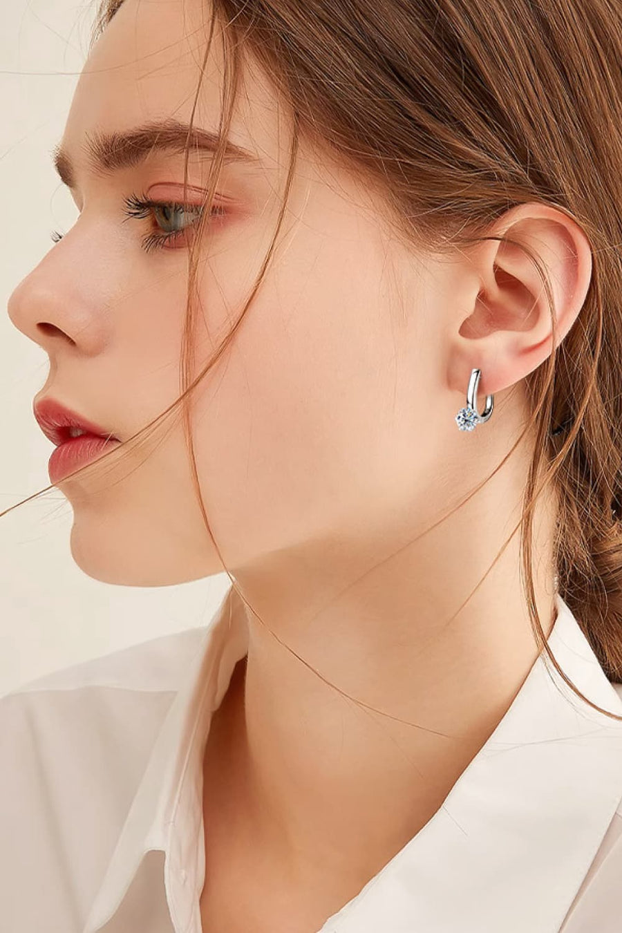 Silver solitaire huggie hoop earrings with a single clear stone, made of 925 silver.