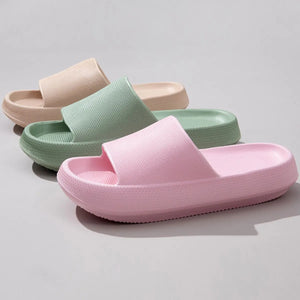 Textured cloud slides slippers in pink, green, and apricot with thick soles.
