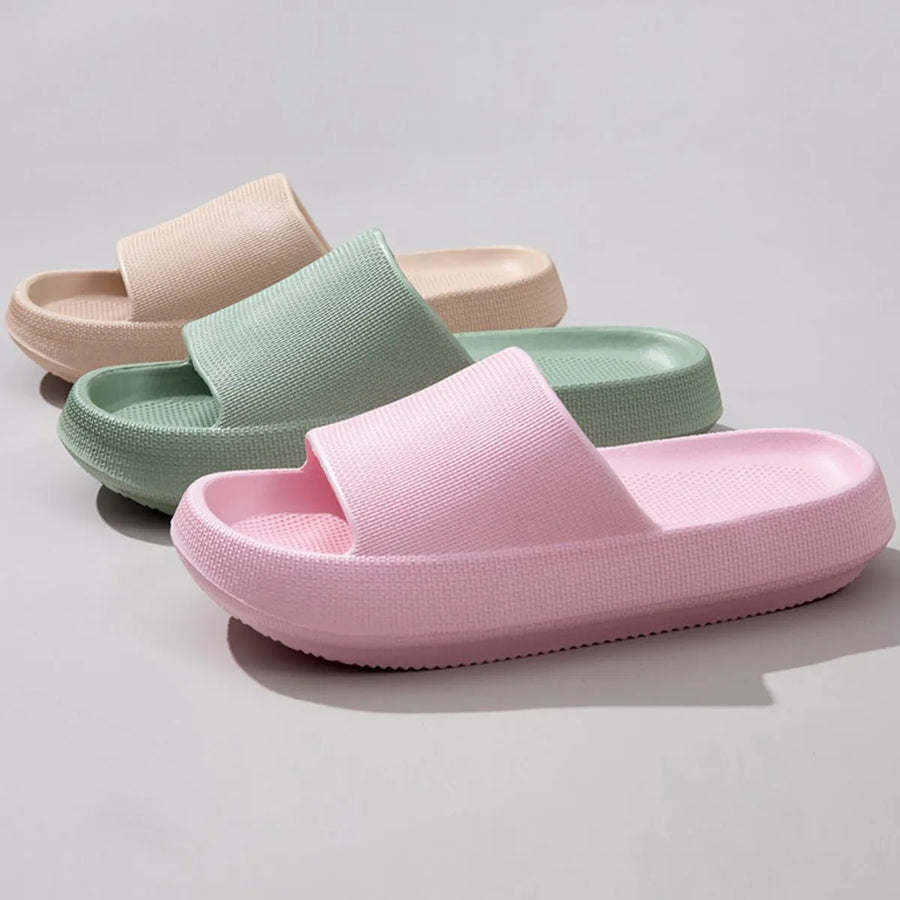 Textured cloud slides slippers in pink, green, and apricot with thick soles.