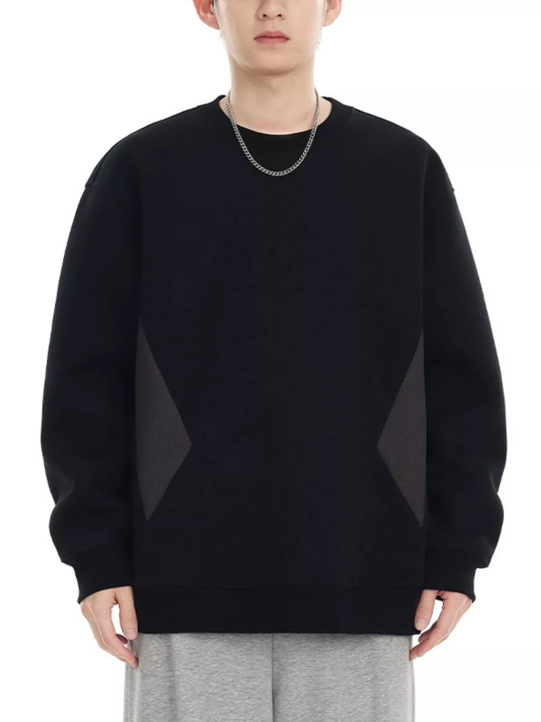 Black oversized cotton crew-neck sweatshirt with dark gray geometric panel details on sides.