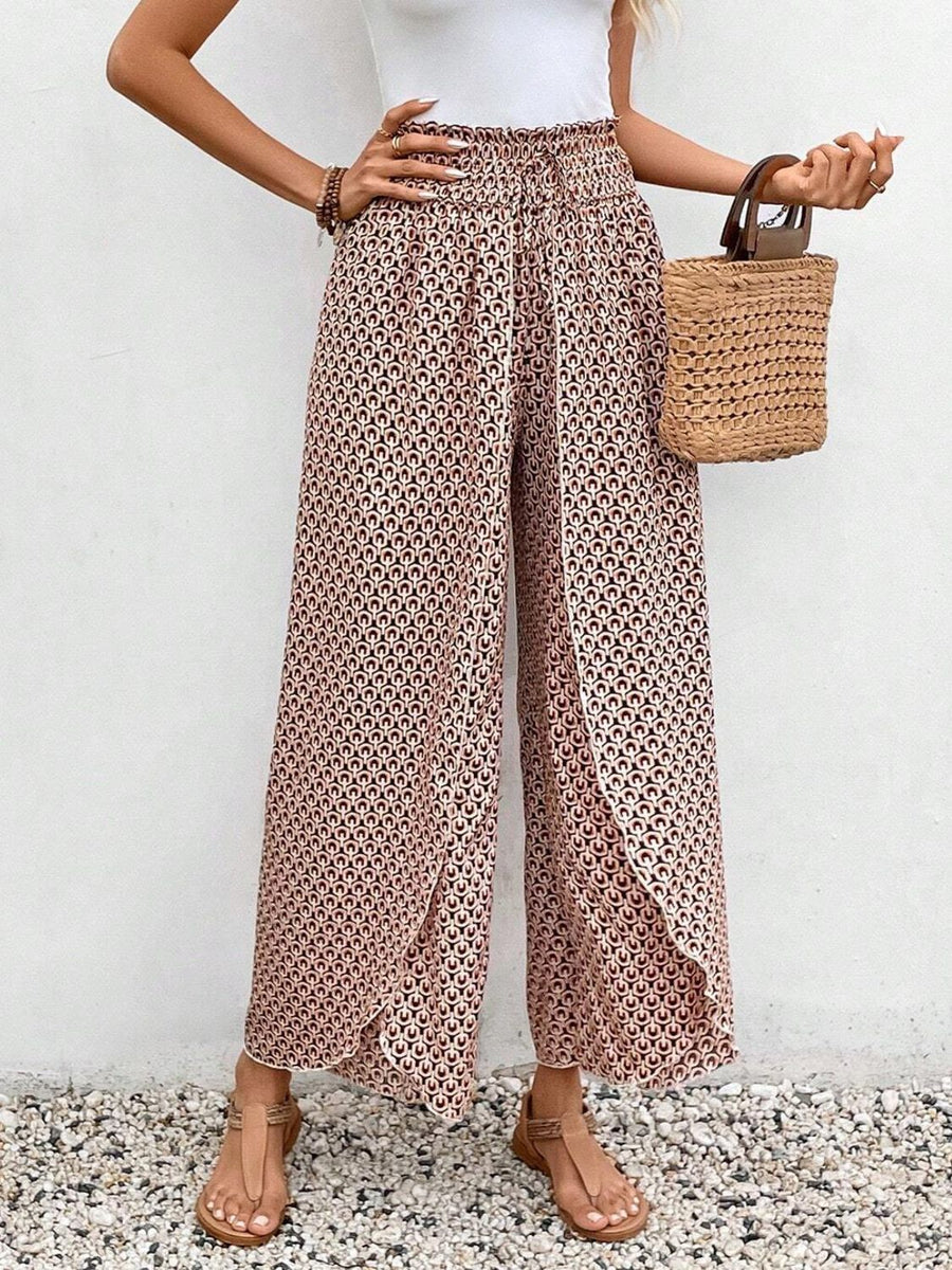 Floral print wrap-front palazzo pants in blush pink with a geometric pattern.