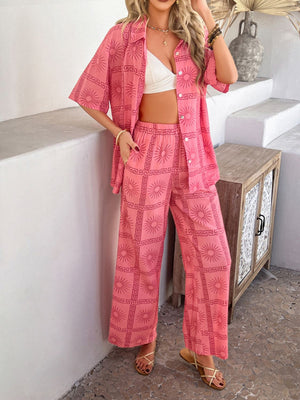 Women's pink abstract print resort co-ord set with wide leg pants and short sleeve button-up shirt.