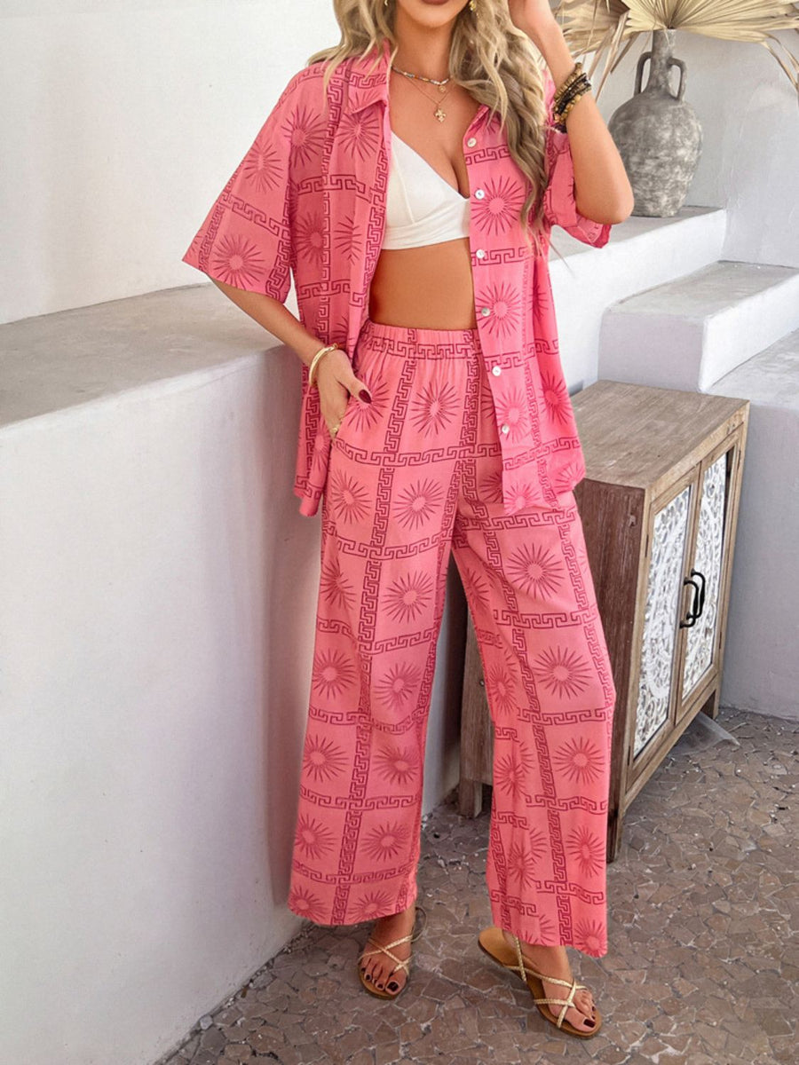 Women's pink abstract print resort co-ord set with wide leg pants and short sleeve button-up shirt.