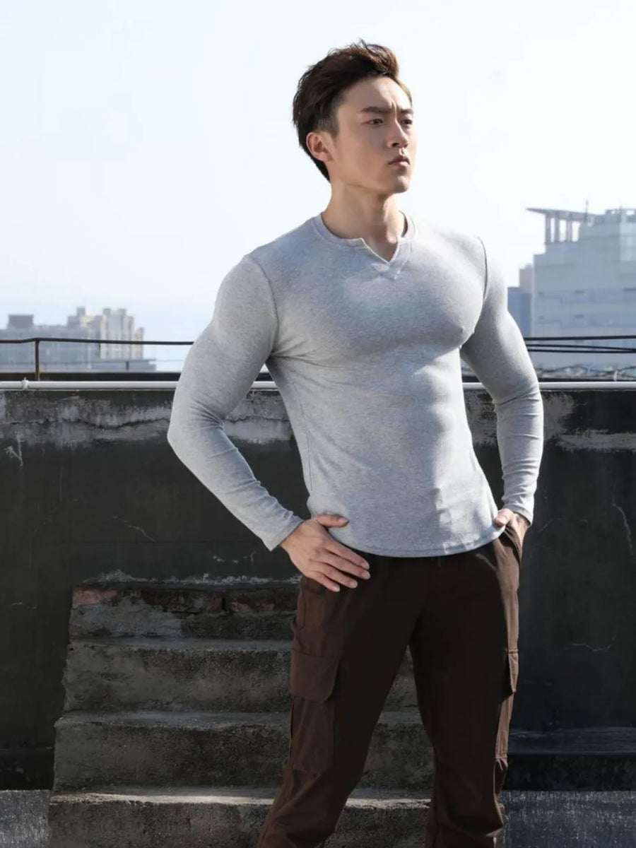 Gray ribbed long sleeve t-shirt with a sculpted V-neck and henley detail.