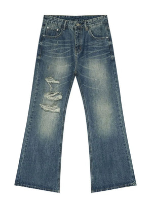 Distressed flare leg jeans in medium wash denim with ripped details.