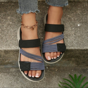 Blue and black multi-strap sandals with adjustable velcro straps and a comfortable sole.