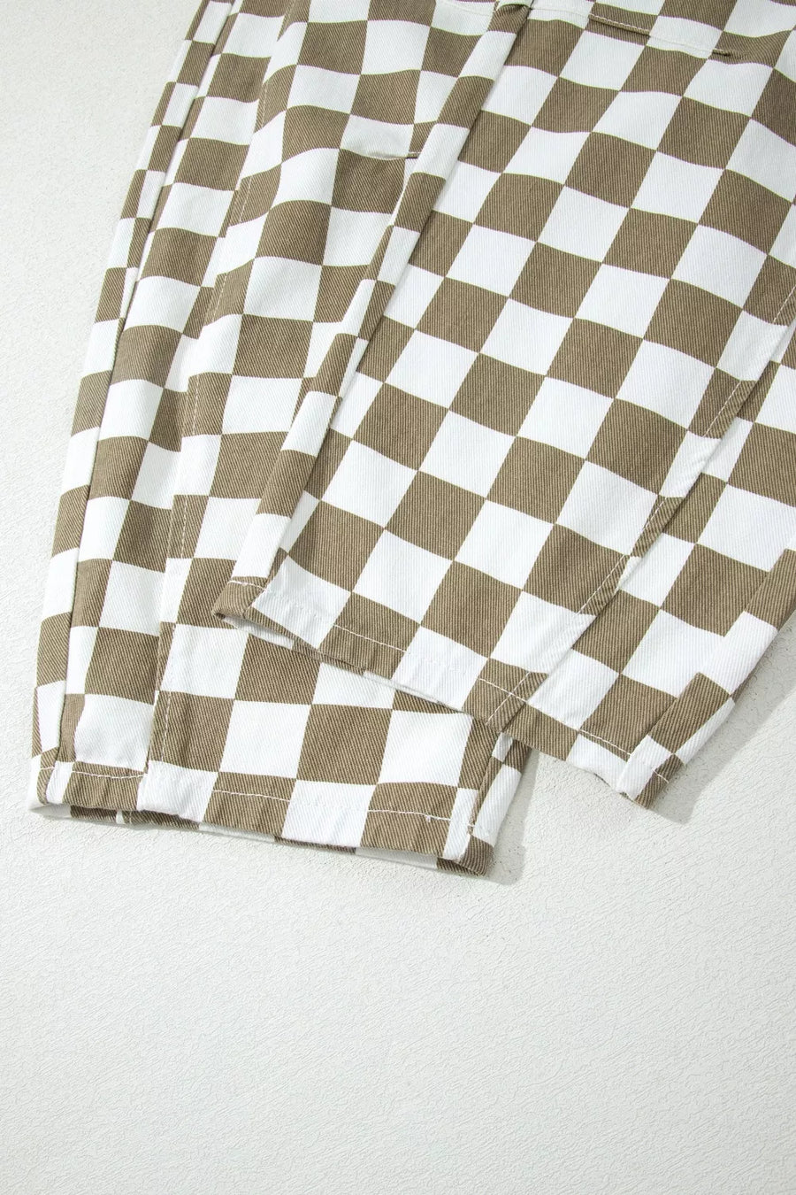 Maternity barrel pants in brown and white checkerboard cotton denim with visible stitching details.
