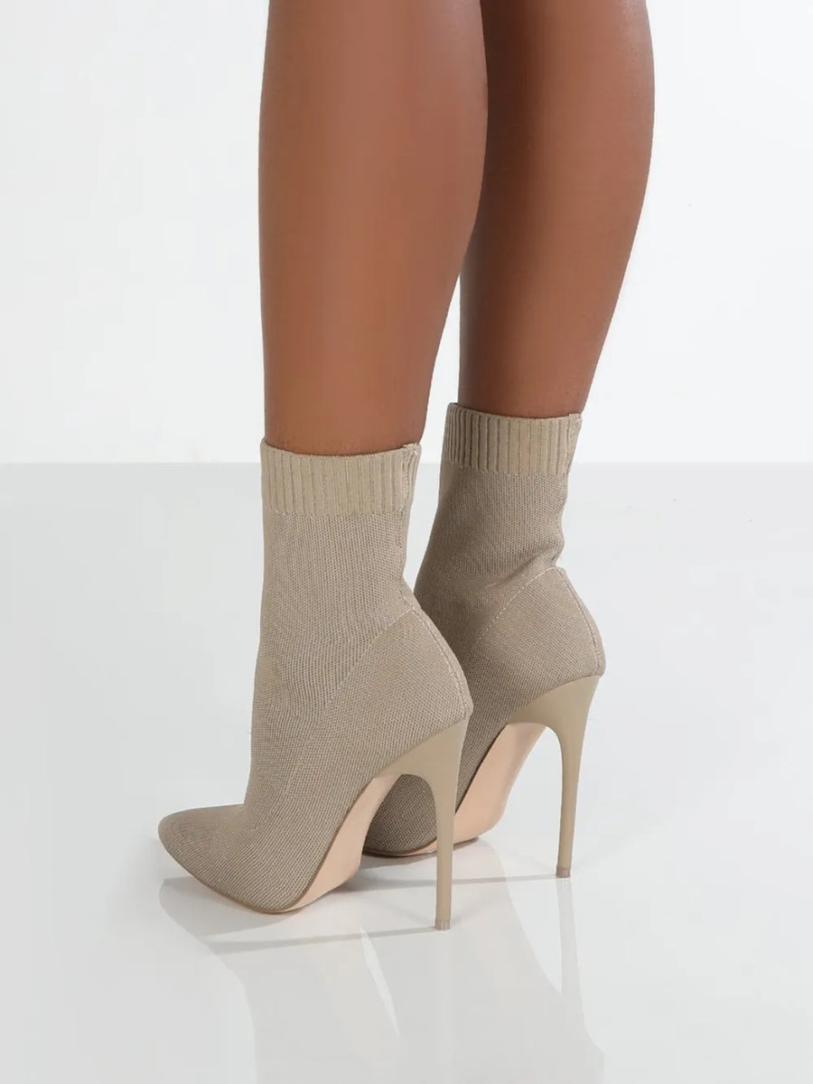 Beige knit sock booties with pointed toe and stiletto heel.