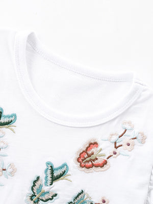 White toddler dress with embroidered butterflies and flowers, round neckline.
