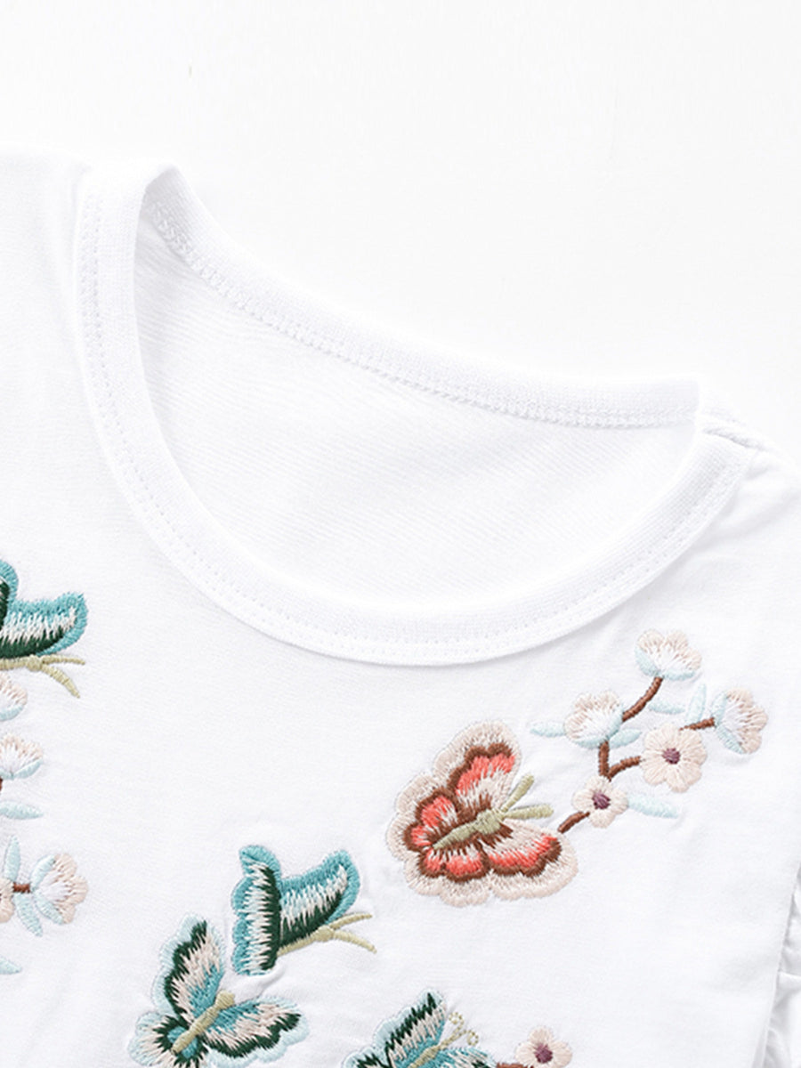 White toddler dress with embroidered butterflies and flowers, round neckline.