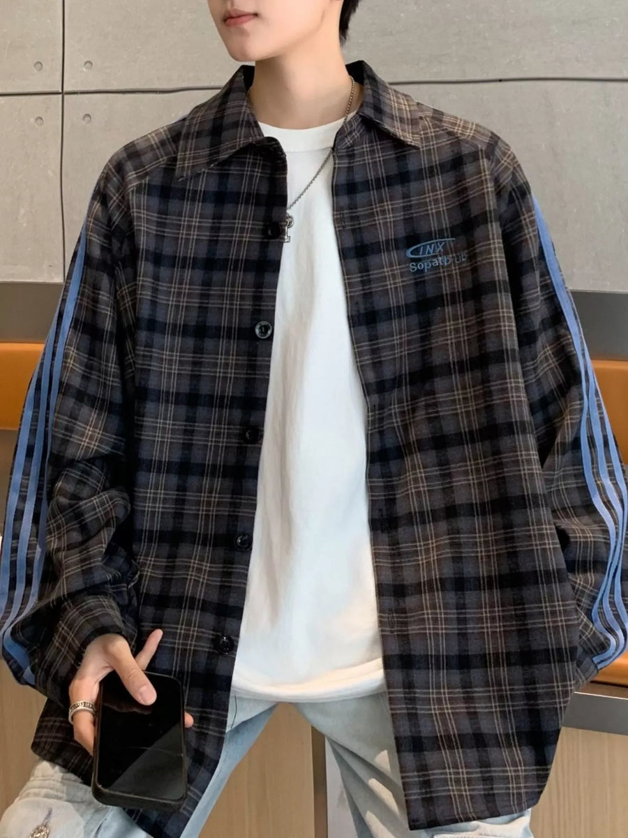 Oversized plaid long-sleeve overshirt in black with blue stripe detail on sleeves.