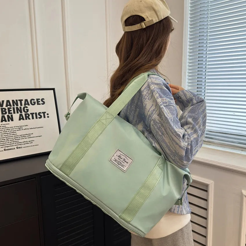 Weekend Escape Nylon Tote in Light Green with dual handles and a shoulder strap.