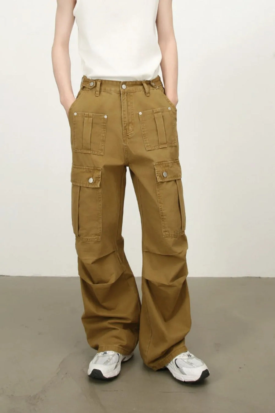 Khaki cargo wide-leg trousers with multiple flap pockets and button details.