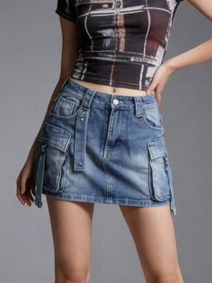 Plus size dark blue washed denim cargo skirt with button closure and utility pockets.