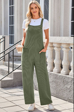 Moss green striped denim overalls with patch pockets and wide legs.