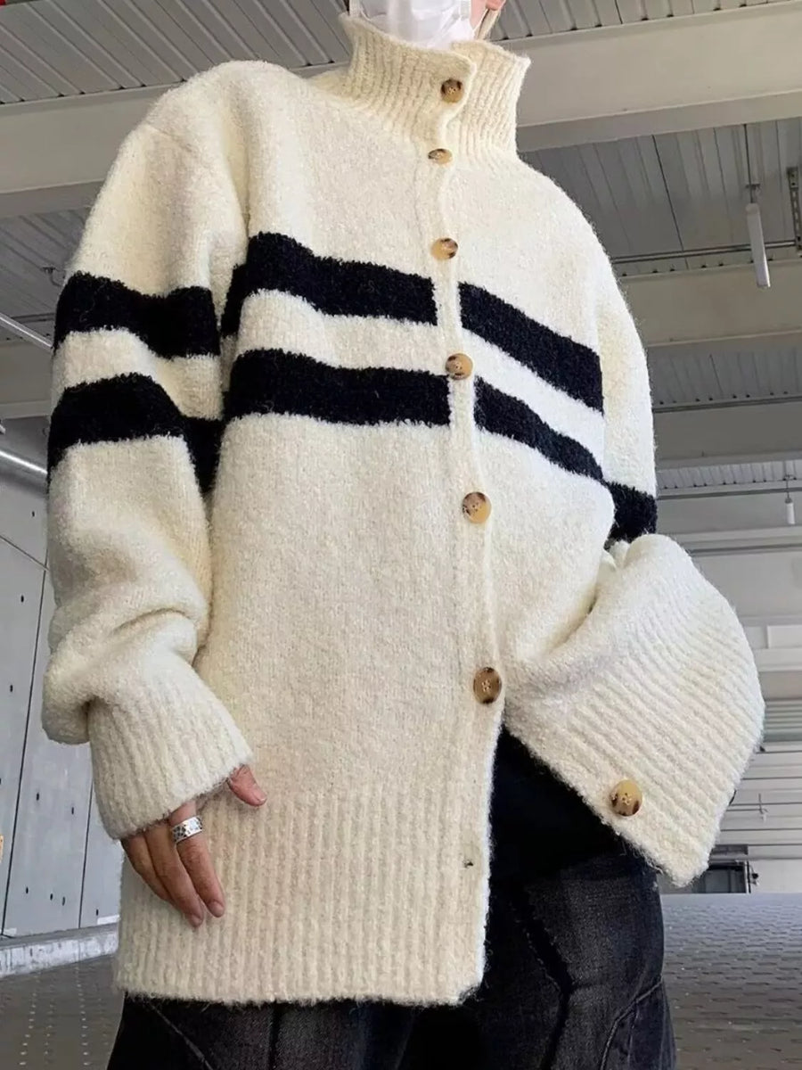 Striped knit cardigan in cream with black horizontal stripes and button-down front.