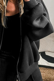 Black zip-up bomber jacket with a relaxed fit and silver zipper detail.