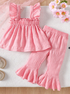Pink cotton blend baby set with ruffled straps and flared pants.