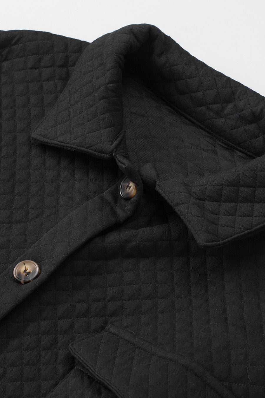 Black quilted overshirt with button details and patch pocket flap.