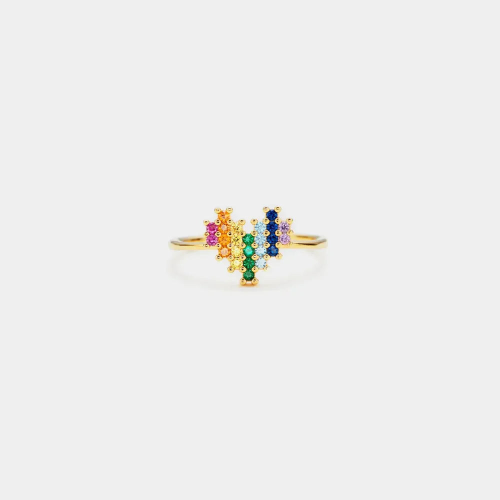 Gold ring with a pixelated rainbow heart design made of colorful cubic zirconia stones.