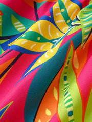 Tropical print midi dress in vibrant pink, green, yellow, and blue.