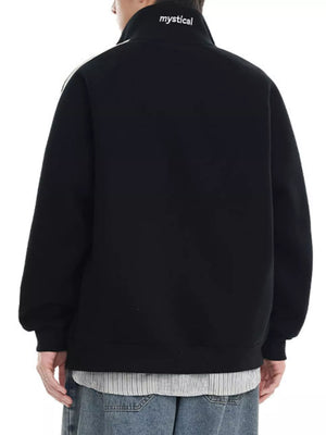 Black zip-up sweatshirt with white stripe detail on shoulder and "mystical" text on collar.