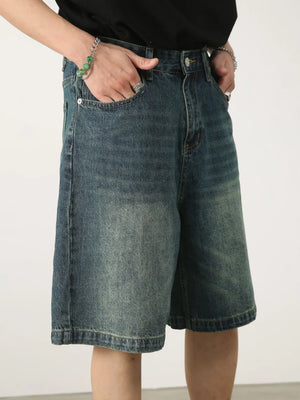 Baggy denim bermuda shorts in light blue with a washed effect and buttoned fly.