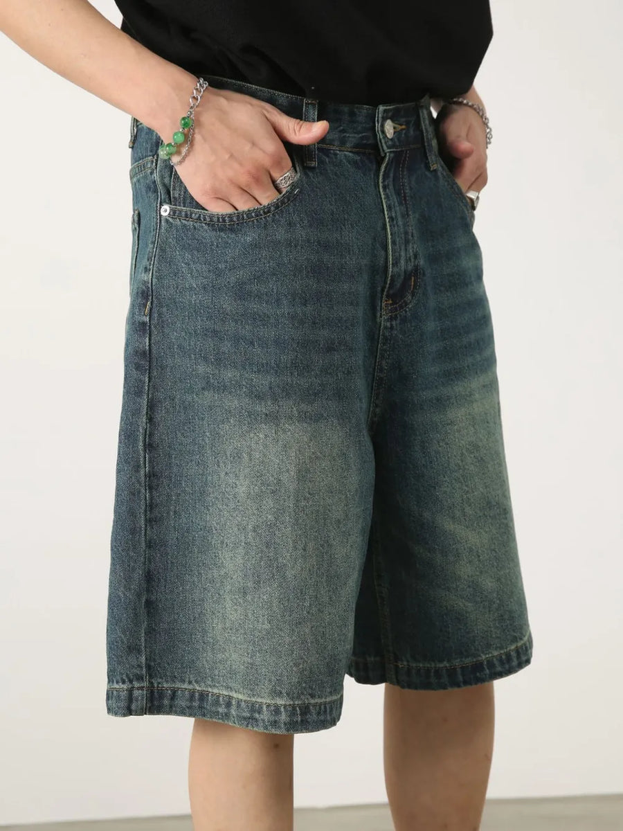 Baggy denim bermuda shorts in light blue with a washed effect and buttoned fly.