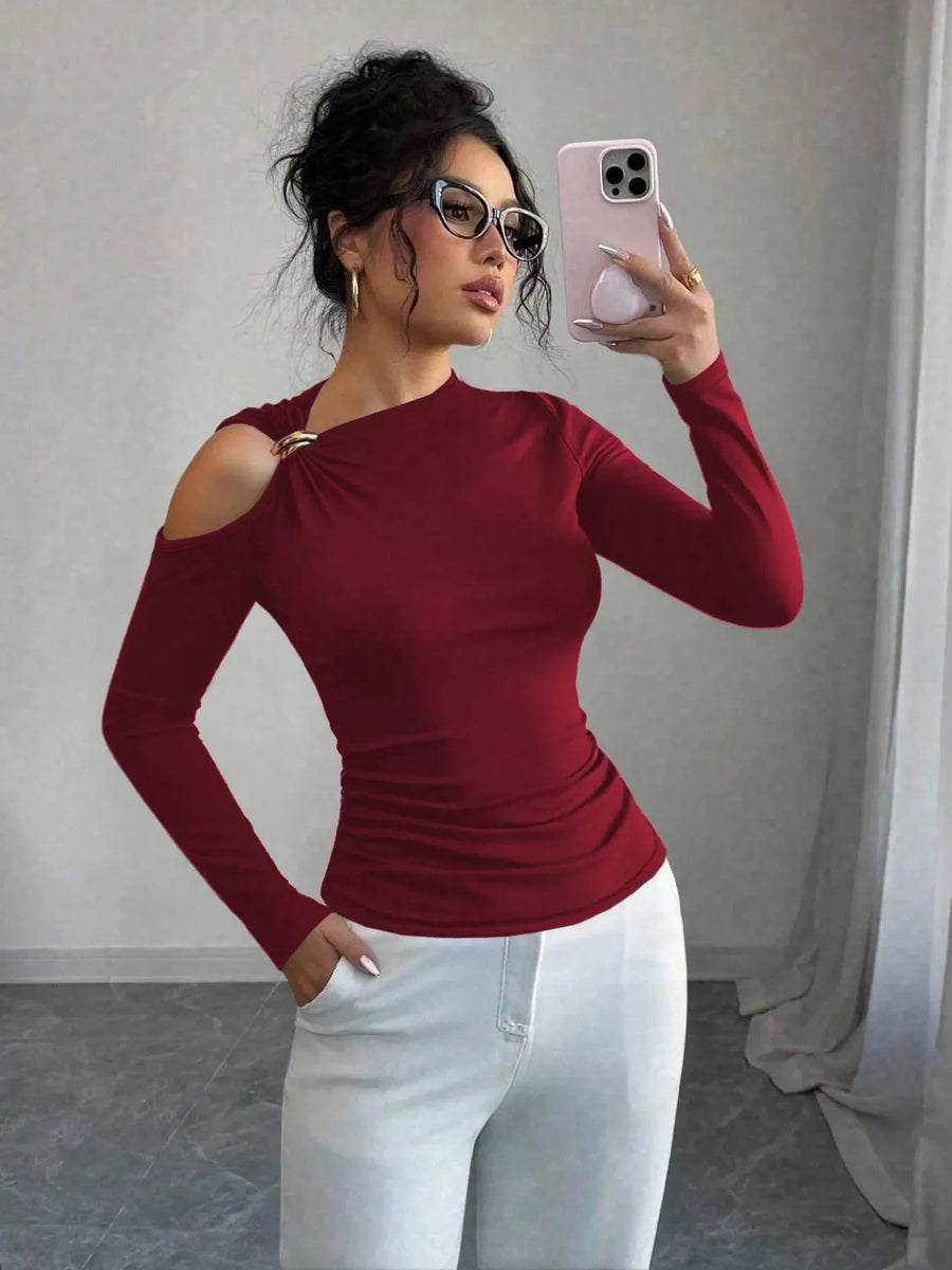 Burgundy long sleeve t-shirt with cutout shoulder detail and gold ring accent.