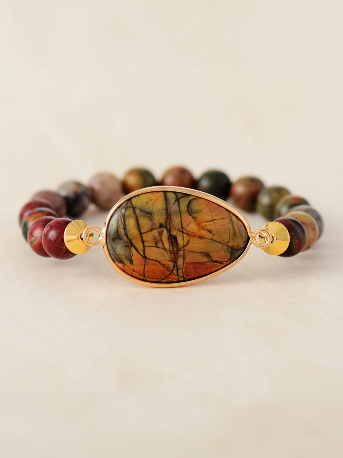Prismatic bead and stone bracelet with a teardrop-shaped agate centerpiece and gold accents.