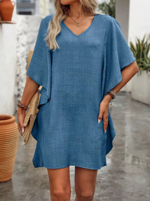 Blue V-neck mini dress with flowy sleeves and textured fabric.