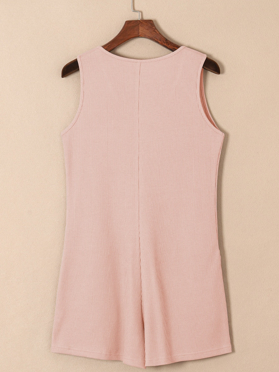 Blush pink waffle knit button-down romper with pockets, sleeveless, round neck