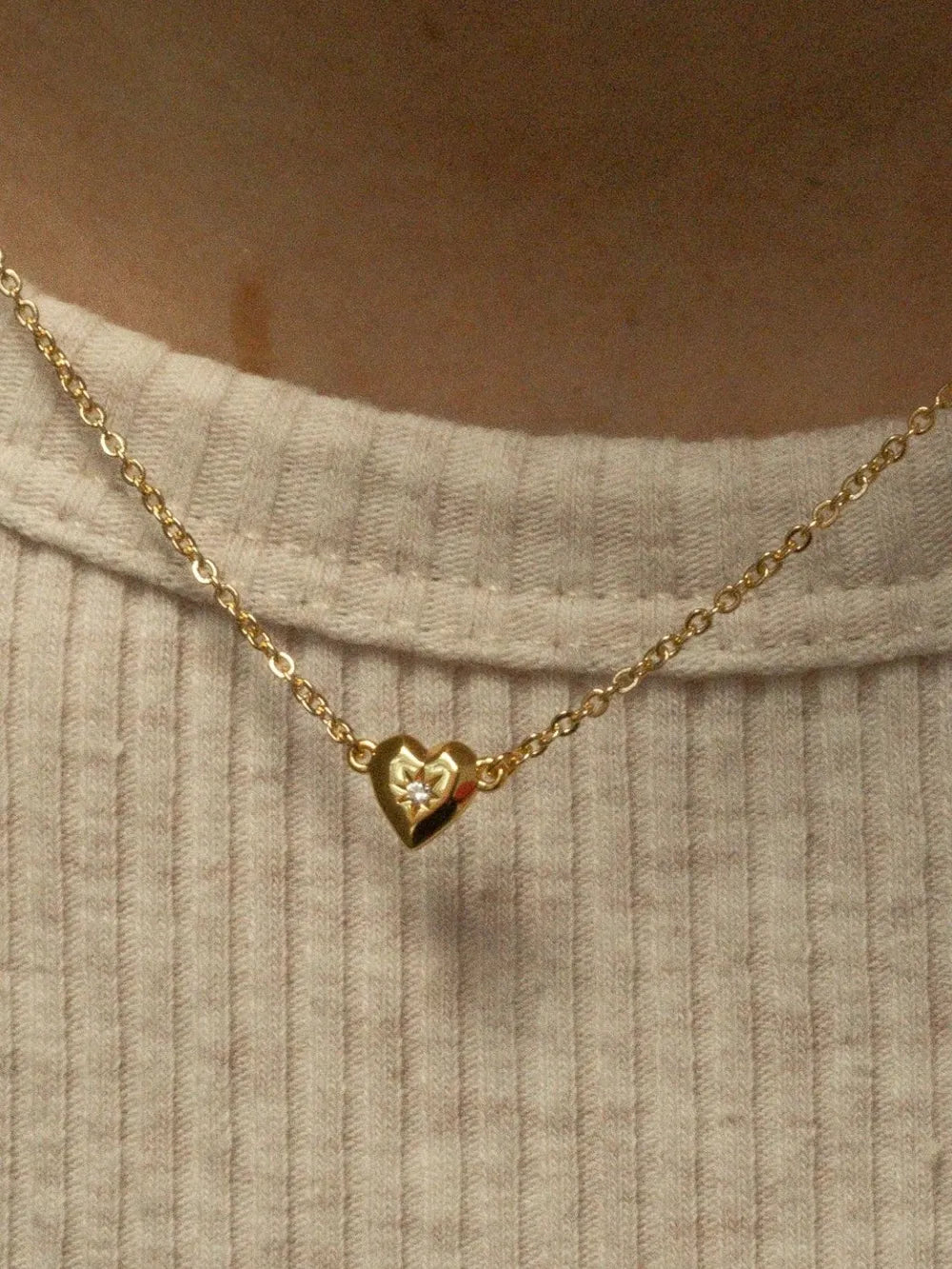Gold heart pendant necklace with diamond accent on delicate chain