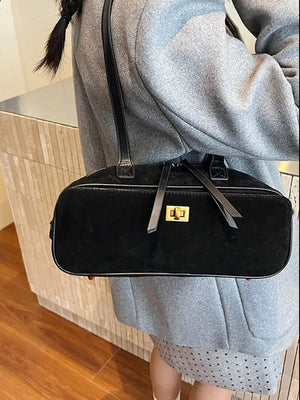 Black suede shoulder bag with gold clasp and leather strap detail