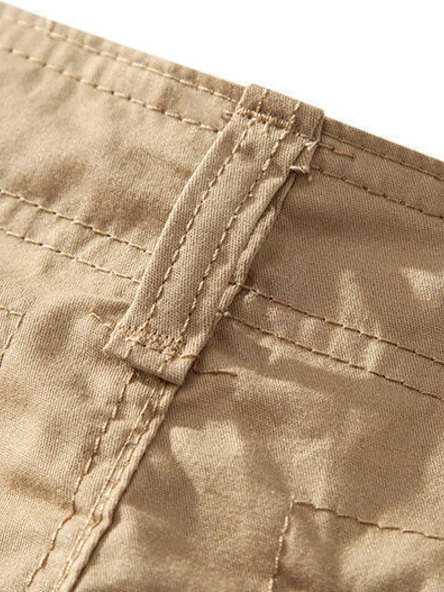 Khaki cargo shorts detail with reinforced stitching and belt loop.