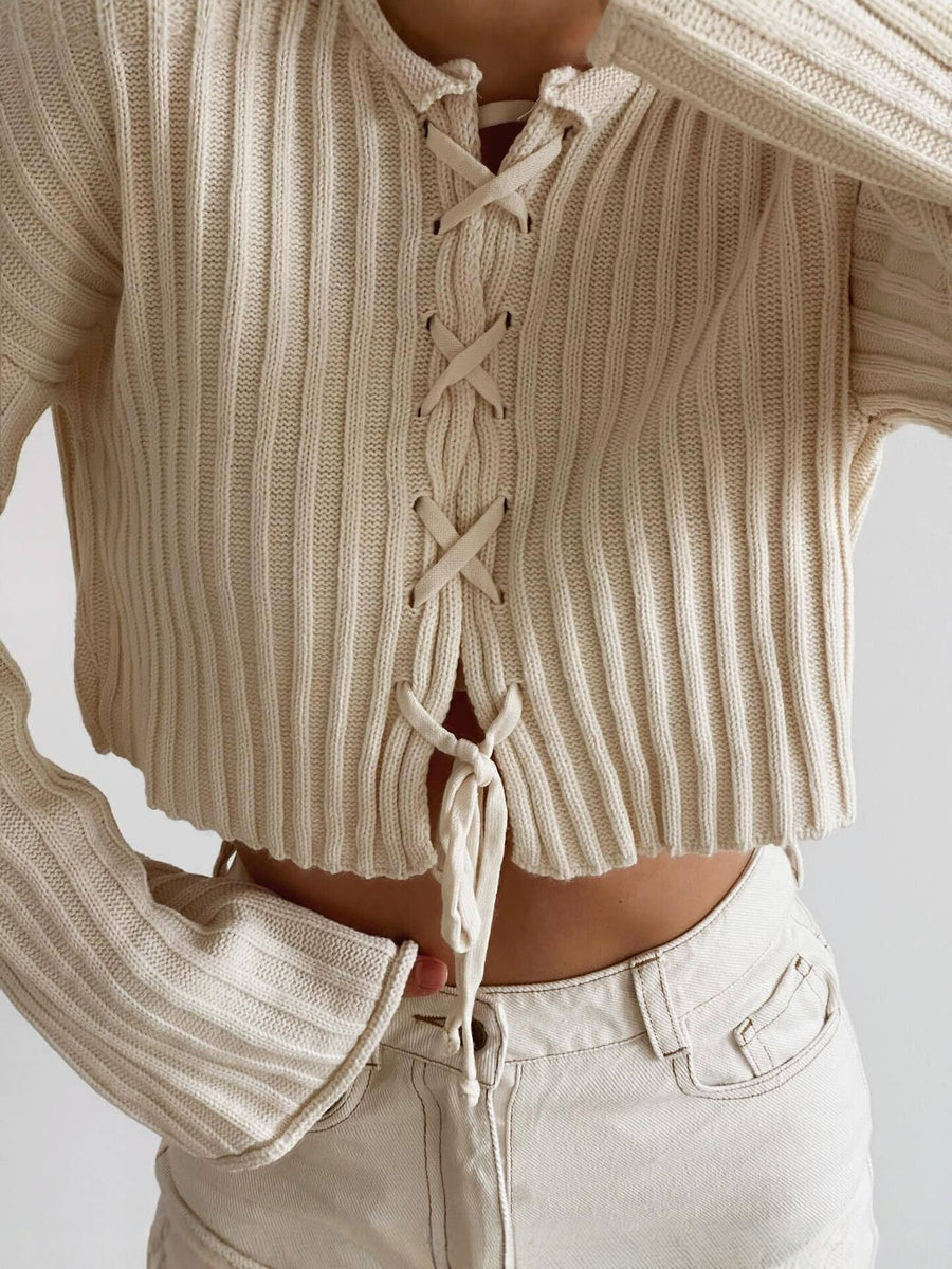 Apricot pullover sweater featuring lace-up and ribbed