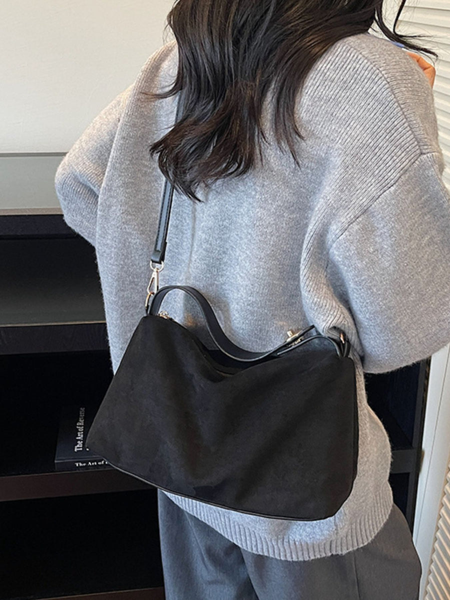 crossbody bag in black featuring adjustable strap and soft fit