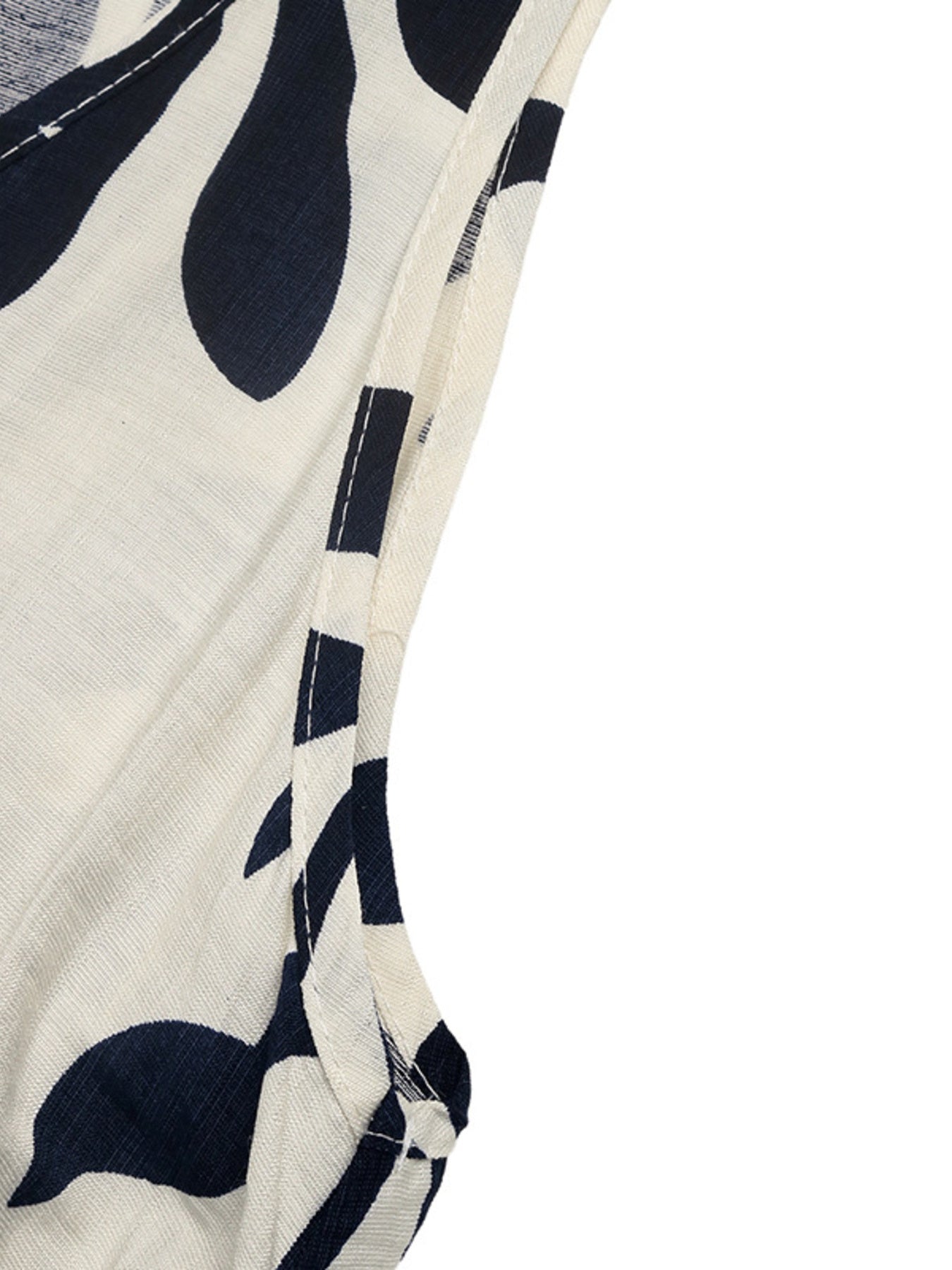 Belted dress with tropical leaf print, decorative buttons, and white trim detail.
