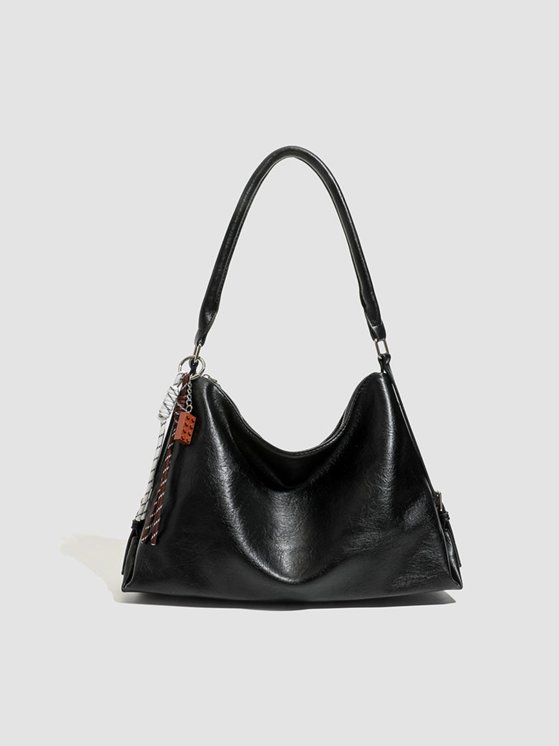 PU Leather Shoulder Bag With Charm in black with decorative charm