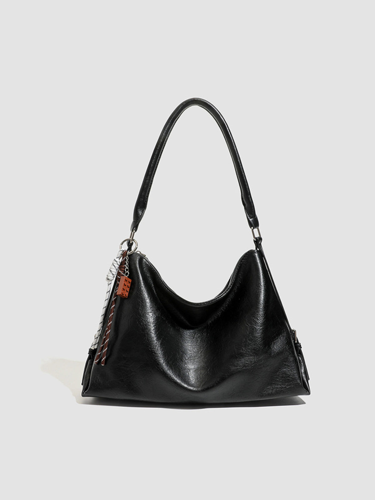 PU Leather Shoulder Bag With Charm in black with decorative charm