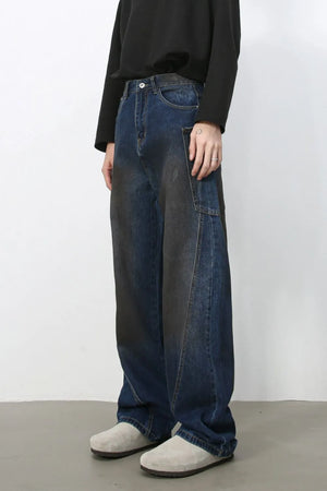 Faded panel wide-leg denim trousers in medium wash with a relaxed fit.